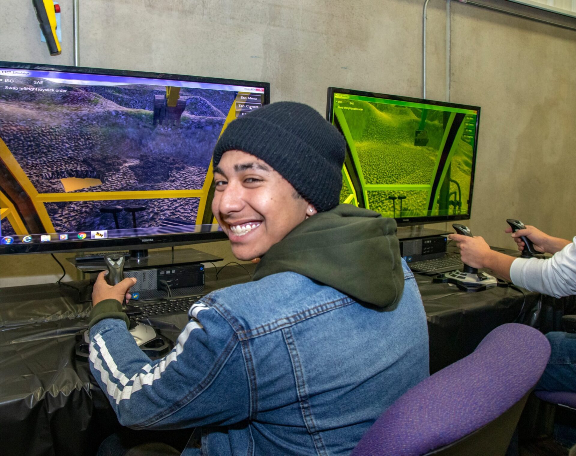 Boy learning on computer about excavators