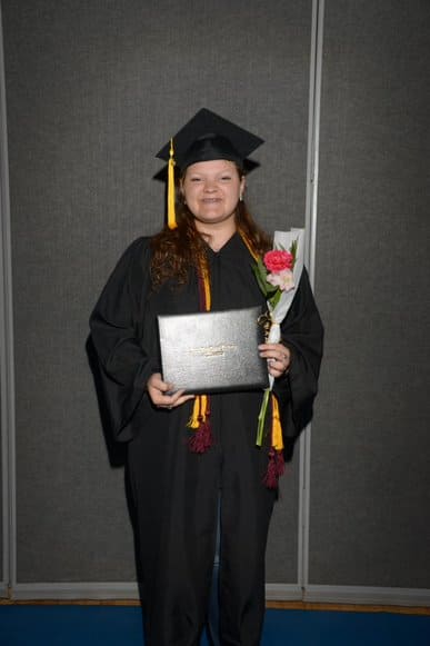 student with diploma and flowers